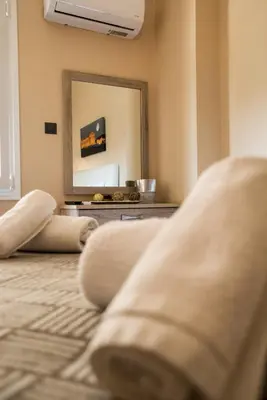 a living room with a mirror and a couch at Gazi Divine Apartment in Athens