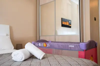 a bedroom with a bed with towels on it at Gazi Divine Apartment in Athens