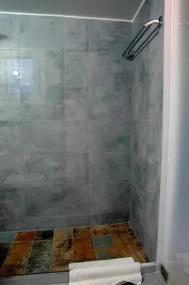 a bathroom with a shower with a tiled shower at Gazi Divine Apartment in Athens