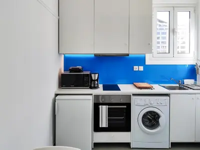 a kitchen with a washing machine and a microwave at KYMA Apartments - Athens Acropolis 8 in Athens