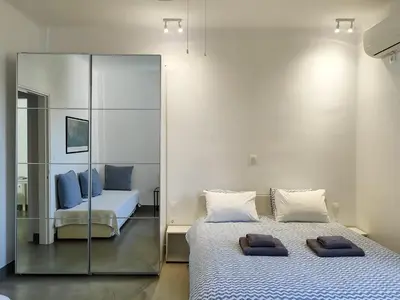 a bedroom with two beds and a mirror at KYMA Apartments - Athens Acropolis 8 in Athens