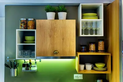 a kitchen with wooden cabinets with plates and glasses at Emerald Suite in Athens