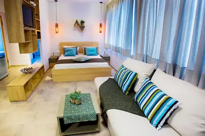 a living room with two beds and a couch at Emerald Suite in Athens