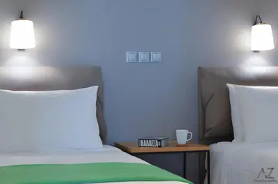 a bedroom with two beds and a table with a cup at Phaedra Apartment in Athens