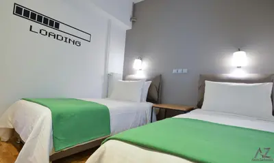 two beds in a room with green and white at Phaedra Apartment in Athens