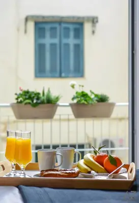 a tray of food and orange juice and fruit on a table at Phaedra Apartment in Athens