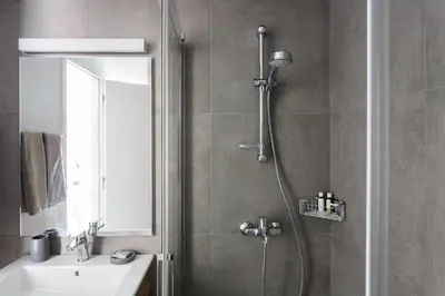 a bathroom with a shower and a sink at Homz Studios Faliro in Athens