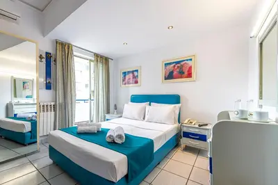 a hotel room with a bed and a window at ROY Hotel in Athens