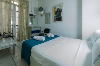 a bedroom with a large bed with towels on it at ROY Hotel in Athens