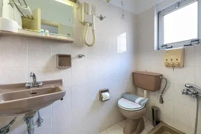 a bathroom with a toilet and a sink at ROY Hotel in Athens