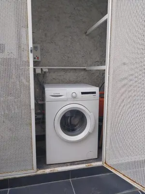 a washer and dryer in a small room at Lovely two-bedroom apartment with roof garden! EP7 in Athens