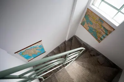 a staircase with two paintings on the wall and a window at Lovely two-bedroom apartment with roof garden! EP7 in Athens