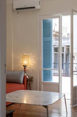 a living room with a couch and a window at Lovely two-bedroom apartment with roof garden! EP7 in Athens