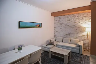a living room with a couch and a table at Paradise Apartment in Peiraiki in Piraeus