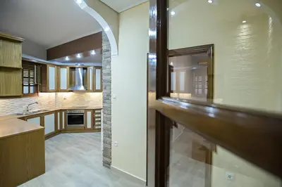 a kitchen with wooden cabinets and a counter top at Paradise Apartment in Peiraiki in Piraeus
