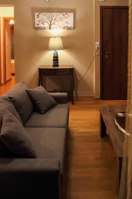 a living room with a couch and a table at Ouranos Apartment in Athens