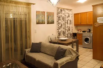 a living room with a couch and a table at Ouranos Apartment in Athens