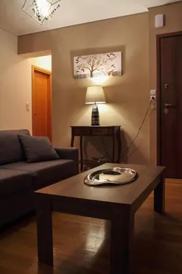 a living room with a couch and a coffee table at Ouranos Apartment in Athens