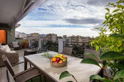 a basket of fruit on a table on a balcony at 165 sm Penthouse Maisonette Apartment in Athens