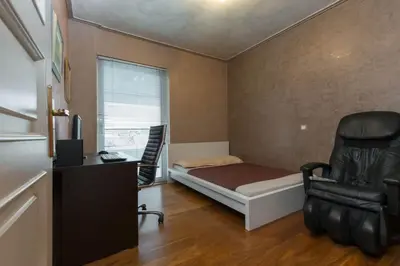 a bedroom with a bed and a desk and a chair at 165 sm Penthouse Maisonette Apartment in Athens