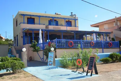 a house with a sign in front of it at Aiolos in Vaia