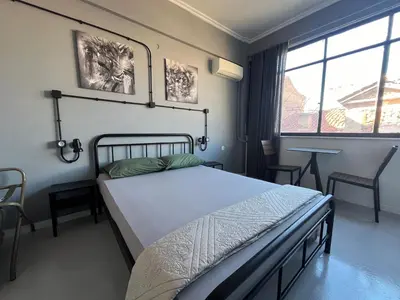 a bedroom with a bed and a large window at Urban Rooms in Athens