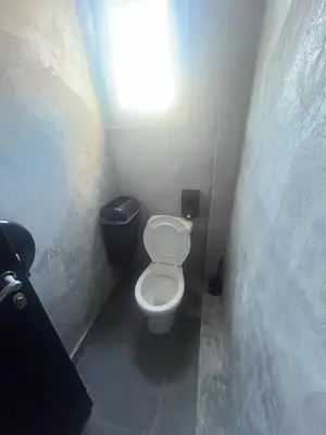 a small bathroom with a toilet and a light at Urban Rooms in Athens
