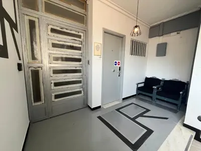 a hallway with a door and a chair in a room at Urban Rooms in Athens