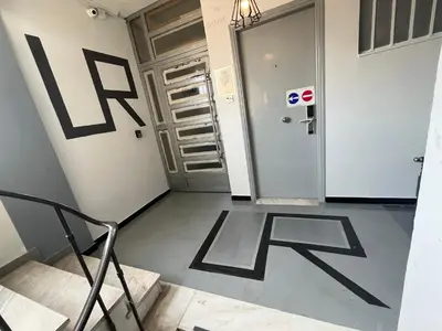 a hallway with stairs and a door with the letter e at Urban Rooms in Athens