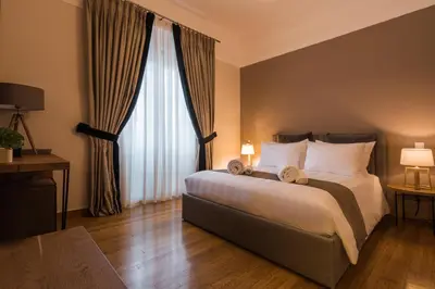 a bedroom with a bed and a large window at Acropolis Exclusive Residences in Athens
