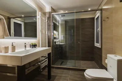 a bathroom with a shower and a sink and a toilet at Acropolis Exclusive Residences in Athens