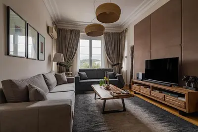 a living room with a couch and a tv at Acropolis Exclusive Residences in Athens