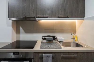 a kitchen with a sink and a counter top at Acropolis Exclusive Residences in Athens
