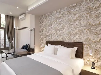 a bedroom with a large white bed and a wall at 18 Micon Str. in Athens