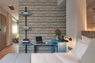 a bedroom with a bed and a desk with a laptop at 18 Micon Str. in Athens