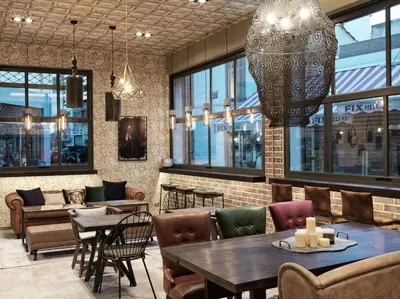 a restaurant with tables and chairs and windows at 18 Micon Str. in Athens