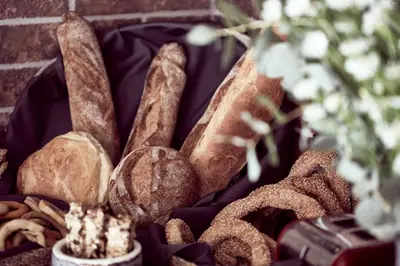 a bunch of different types of bread in a basket at 18 Micon Str. in Athens
