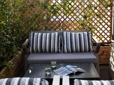 a bench sitting on a patio with a table at 18 Micon Str. in Athens