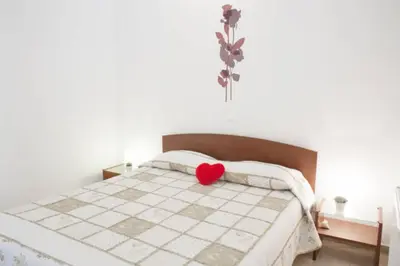 a bedroom with a bed with a red heart on it at Thelma's Apartment in Athens