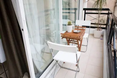 a balcony with a table and chairs on a balcony at Thelma's Apartment in Athens