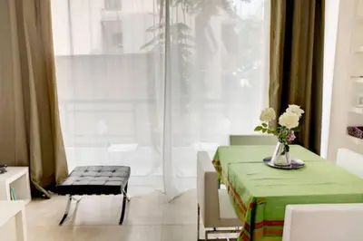a room with a table and a chair and a window at Thelma's Apartment in Athens