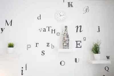 a wall with letters and a clock on it at Thelma's Apartment in Athens