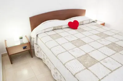 a bedroom with a bed with a red heart on it at Thelma's Apartment in Athens