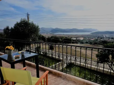 a balcony with a table and chairs and a view at Villa Christina in Anavissos