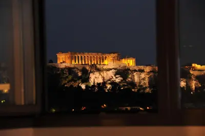 a view of the acropolis at night from a window at Acropolis at Home: Loft with a View in Athens