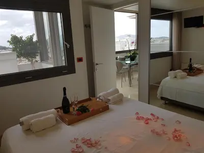 a room with a bed with flowers on it at Acropolis at Home: Loft with a View in Athens