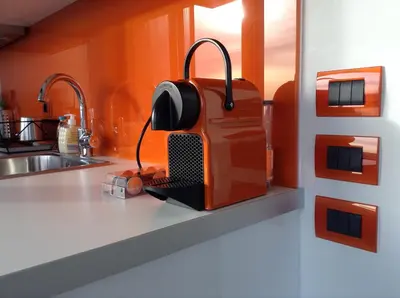 an orange toaster sitting on a counter in a kitchen at Acropolis at Home: Loft with a View in Athens