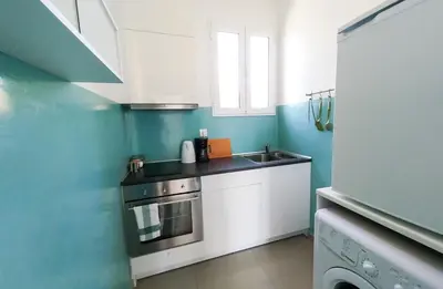 a small kitchen with white cabinets and a sink at KYMA Apartments - Athens Acropolis 6 in Athens