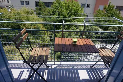 a table and chairs on top of a balcony at KYMA Apartments - Athens Acropolis 6 in Athens
