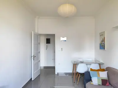 a living room with a table and a couch at KYMA Apartments - Athens Acropolis 6 in Athens